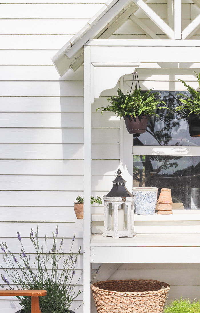 DIY potting bench with decorative roof.