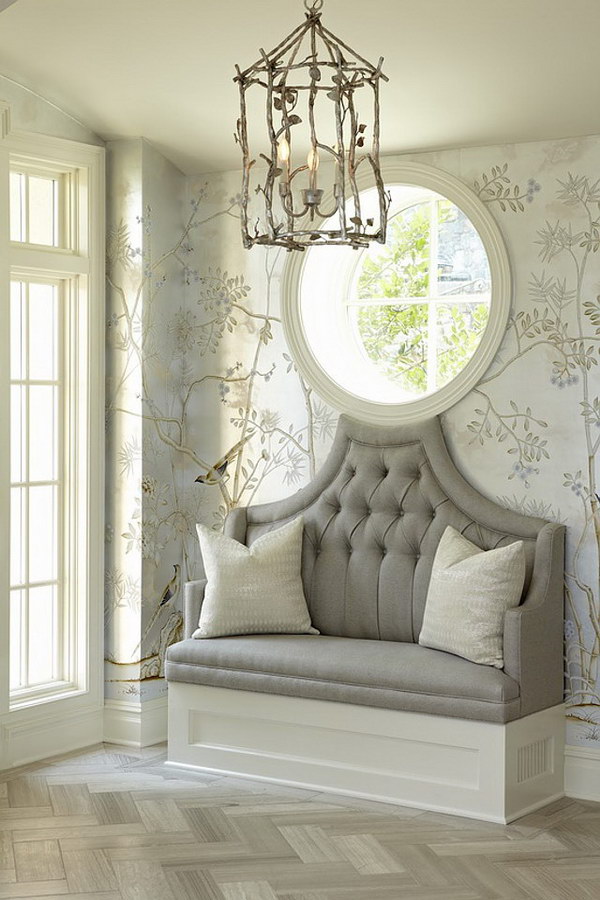 Small Entryway with Upholstered Bench, Antique Pendant Light and Round Window Design.