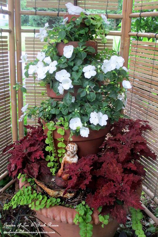 Tiered planter of impatiens, coleus, and creeping jenny.