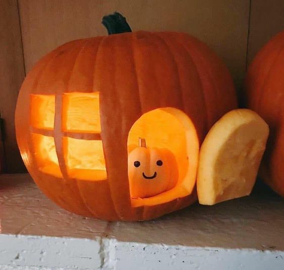 A PUMPKIN MAN SITS INSIDE A PUMPKIN HOUSE.