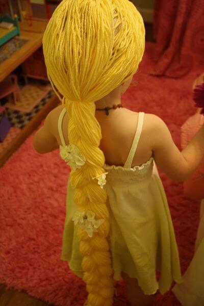 Create a long Rapunzel wig using yarn.