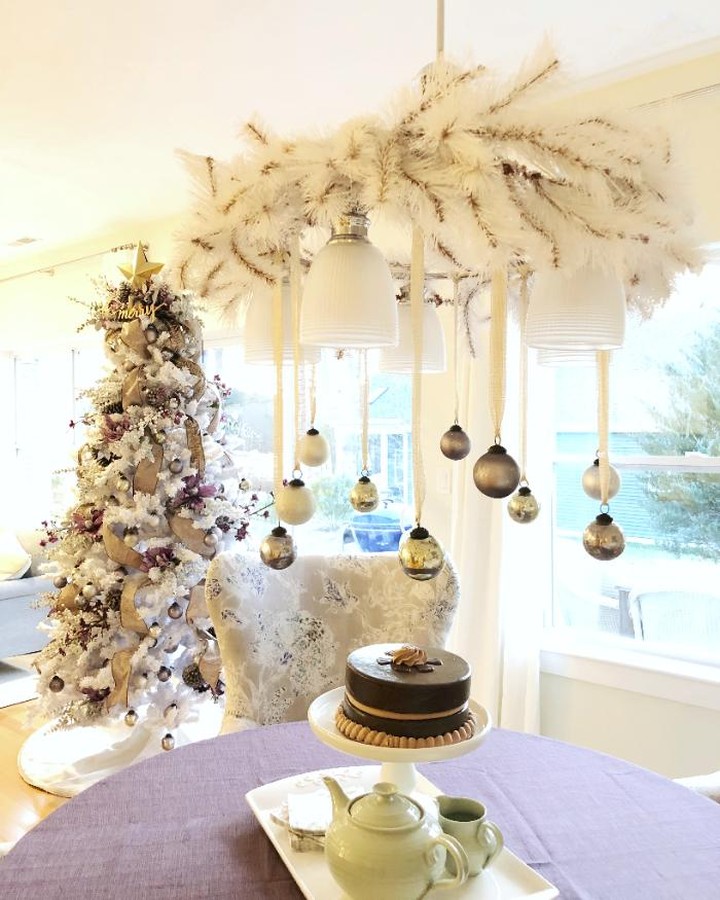 White garland around this chandelier and hung ornaments around at various heights.
