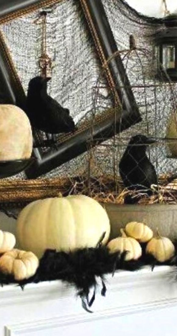 Scary Halloween Mantel decor with white pumpkins and crows.