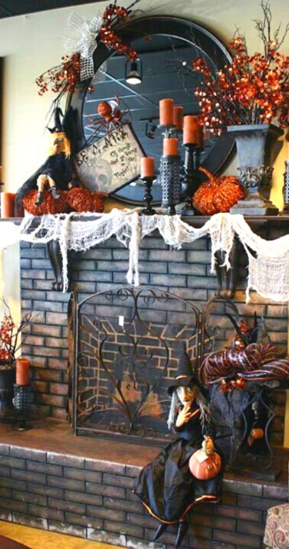 Vintage style Halloween Mantel decor with Witch cheese cloth as web candles and lights.