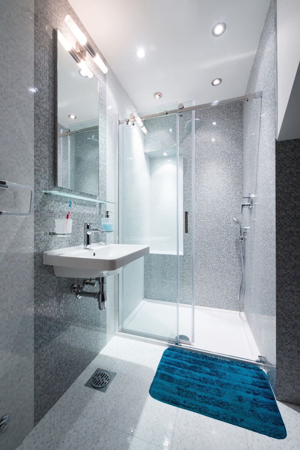 Install a corner shower with a hinged glass panel
